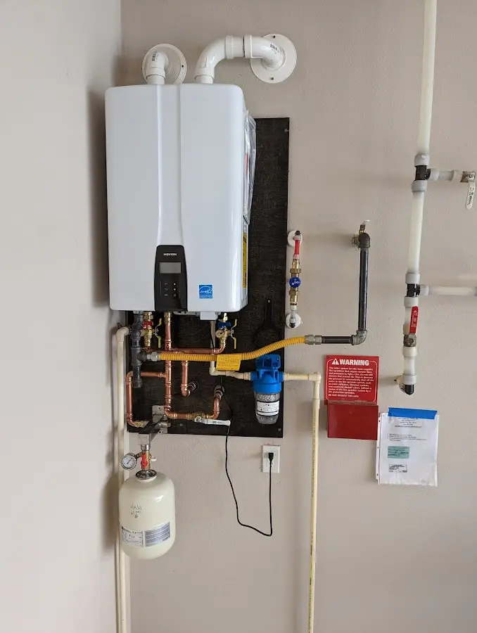 Professional plumber installing copper piping in a Roselawn home